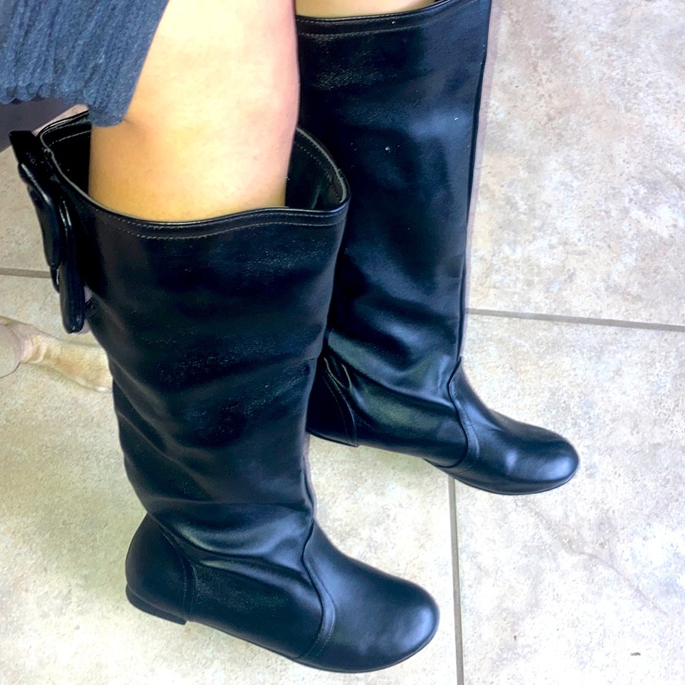 Black knee high boots with bows on back